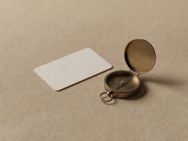 Softly lit 3D render of a transit card and brass pocket compass on sand paper